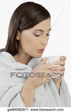 Woman taking hot drink View Large Photo Image Stock Image - Woman taking hot drink. Fotosearch