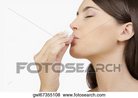 Stock Photo - Woman taking medicine. Fotosearch