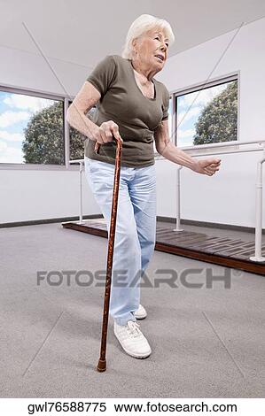 Woman walking with a cane View Large Photo Image Stock Photography - Woman walking with a cane. Fotosearch