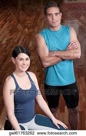 Woman with a man smiling in a gym View Large Photo Image Stock Image - Woman with a man smiling in a gym. Fotosearch