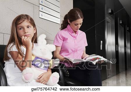 Woman with her daughter in a hospital waiting room View Large Photo Image Stock Image - Woman with her daughter in a hospital waiting room. Fotosearch