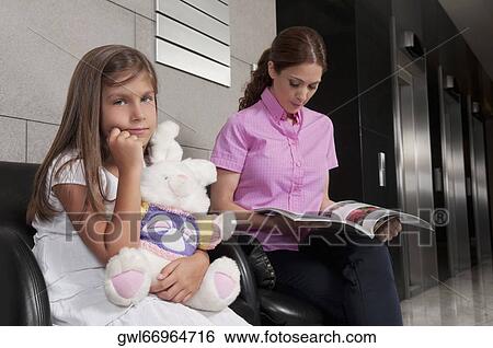 Woman with her daughter in a hospital waiting room View Large Photo Image Stock Photograph - Woman with her daughter in a hospital waiting room. Fotosearch