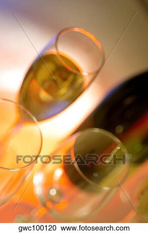 Close-up of a champagne bottle with three champagne flutes View Large Photo Image Stock Image - Close-up of a champagne bottle with three champagne flutes. Fotosearch