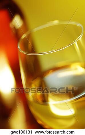 Close-up of a glass of wine with a wine bottle View Large Photo Image Stock Image - Close-up of a glass of wine with a wine bottle. Fotosearch