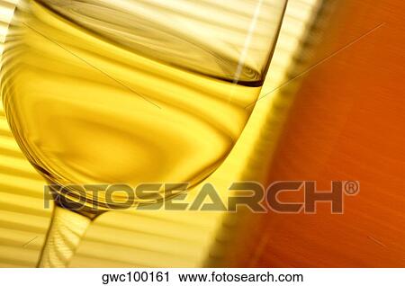 Close-up of a glass of wine with a wine bottle View Large Photo Image Stock Image - Close-up of a glass of wine with a wine bottle. Fotosearch