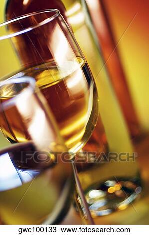 Close-up of two wineglasses with a wine bottle View Large Photo Image Stock Image - Close-up of two wineglasses with a wine bottle. Fotosearch