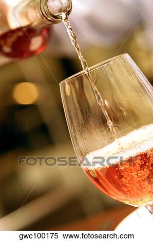 Close-up of wine being poured into a wineglass View Large Photo Image Stock Photography - Close-up of wine being poured into a wineglass. Fotosearch