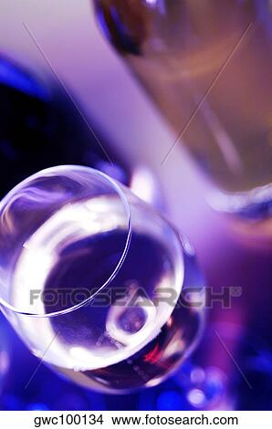 Picture - High angle view of a glass of wine with a wine bottle. Fotosearch