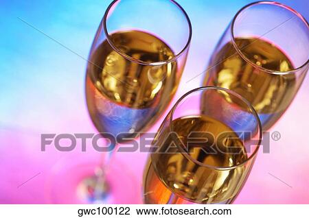 High angle view of champagne in three champagne flutes View Large Photo Image Stock Image - High angle view of champagne in three champagne flutes. Fotosearch