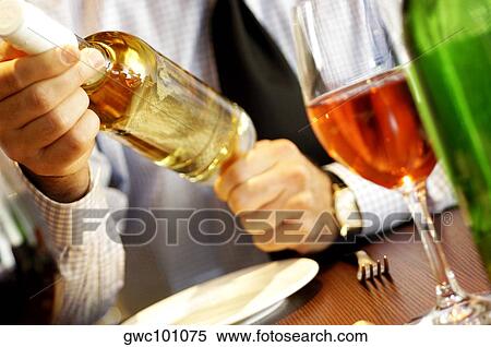 Close-up of a person's hand holding a glass of wine View Large Photo Image Stock Photography - Close-up of a person's hand holding a glass of wine. Fotosearch