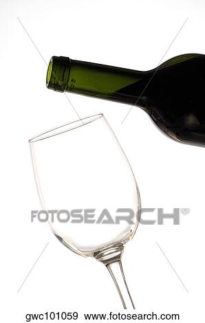 Close-up of a wineglass and a wine bottle View Large Photo Image Stock Photo - Close-up of a wineglass and a wine bottle. Fotosearch