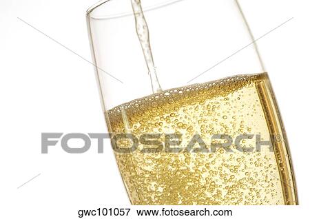 Close-up of champagne being poured into a champagne flute View Large Photo Image Stock Photo - Close-up of champagne being poured into a champagne flute. Fotosearch