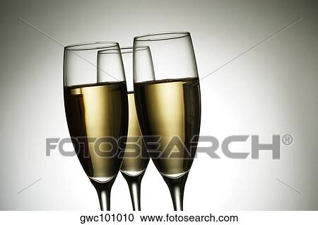 Close-up of champagne in three champagne flutes View Large Photo Image Stock Image - Close-up of champagne in three champagne flutes. Fotosearch