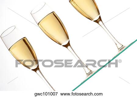Close-up of champagne in three champagne flutes View Large Photo Image Stock Photo - Close-up of champagne in three champagne flutes. Fotosearch