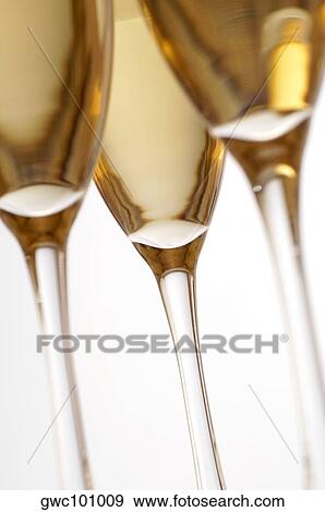 Close-up of champagne in three champagne flutes View Large Photo Image Stock Photo - Close-up of champagne in three champagne flutes. Fotosearch