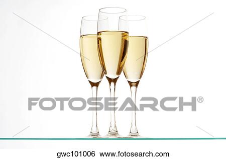 Close-up of champagne in three champagne flutes View Large Photo Image Stock Photograph - Close-up of champagne in three champagne flutes. Fotosearch