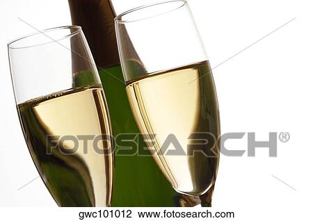 Close-up of champagne in two champagne flutes with a bottle of champagne View Large Photo Image Stock Image - Close-up of champagne in two champagne flutes with a bottle of champagne. Fotosearch
