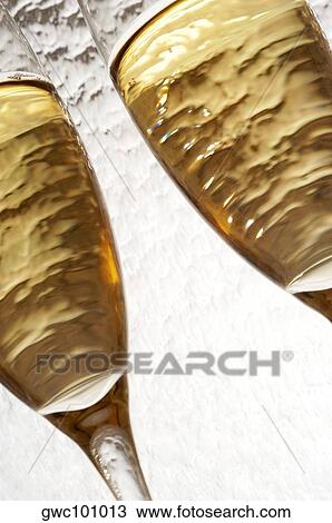 Close-up of champagne in two champagne flutes View Large Photo Image Stock Image - Close-up of champagne in two champagne flutes. Fotosearch