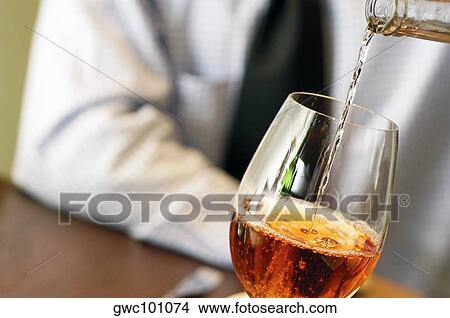 Close-up of wine being poured into a wineglass View Large Photo Image Picture - Close-up of wine being poured into a wineglass. Fotosearch