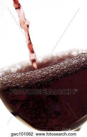 Close-up of wine being poured into a wineglass View Large Photo Image Stock Image - Close-up of wine being poured into a wineglass. Fotosearch
