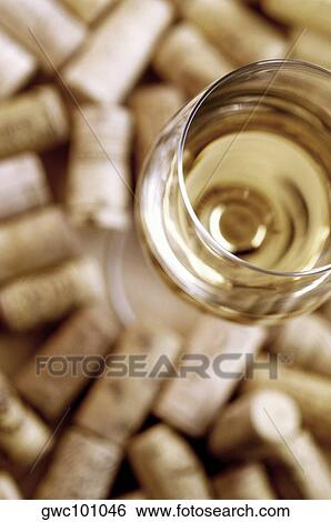 High angle view of a glass of wine with corks View Large Photo Image Stock Photograph - High angle view of a glass of wine with corks. Fotosearch
