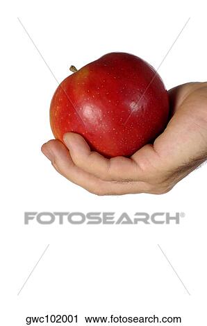 Stock Image - Close-up of a businessman holding an apple. Fotosearch