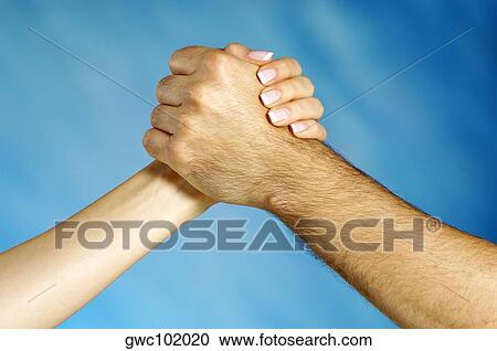 Close-up of a man and a woman arm wrestling View Large Photo Image Stock Image - Close-up of a man and a woman arm wrestling. Fotosearch