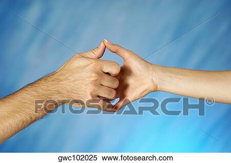 Stock Photography - Close-up of a man and a woman holding hands. Fotosearch