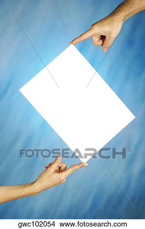 Picture - Close-up of a man and a woman's hands holding a placard. Fotosearch