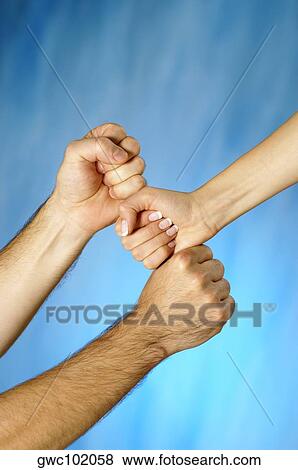 Close-up of a man and a woman's hands stacking fists View Large Photo Image Stock Photo - Close-up of a man and a woman's hands stacking fists. Fotosearch