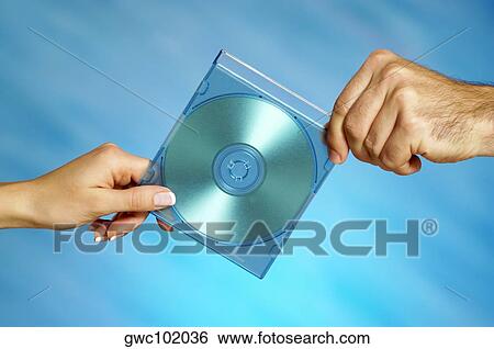 Close-up of a man and a woman's hands holding a compact disk View Large Photo Image Stock Photograph - Close-up of a man and a woman's hands holding a compact disk. Fotosearch