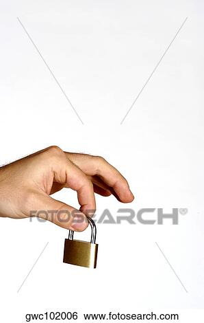 Close-up of a person's hand holding a padlock View Large Photo Image Stock Photograph - Close-up of a person's hand holding a padlock. Fotosearch