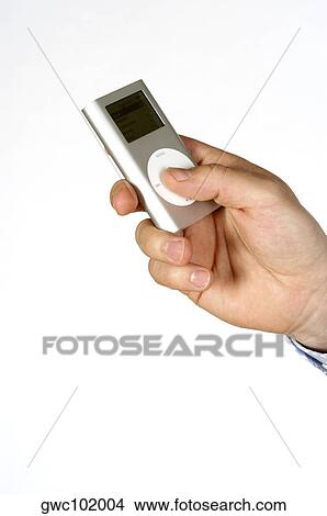 Picture - Close-up of a person's hand holding an MP3 Player. Fotosearch