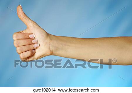 Close-up of a woman's hand making a thumbs up sign View Large Photo Image Picture - Close-up of a woman's hand making a thumbs up sign. Fotosearch