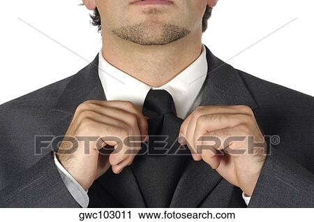Close-up of a businessman adjusting his tie View Large Photo Image Stock Image - Close-up of a businessman adjusting his tie. Fotosearch