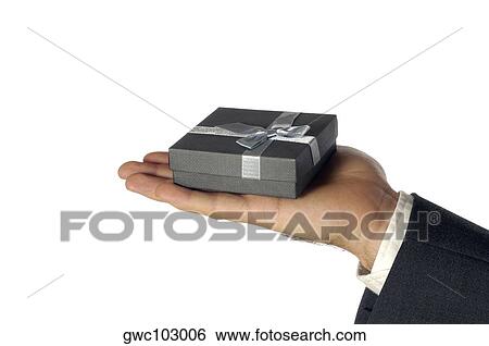 Close-up of a businessman holding a gift View Large Photo Image Stock Photograph - Close-up of a businessman holding a gift. Fotosearch