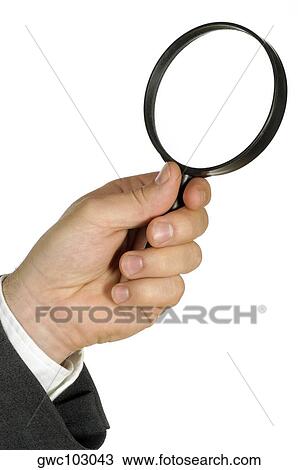 Close-up of a businessman holding a magnifying glass View Large Photo Image Stock Image - Close-up of a businessman holding a magnifying glass. Fotosearch