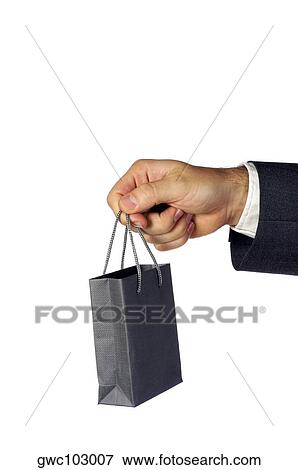 Stock Photo - Close-up of a businessman holding a shopping bag. Fotosearch