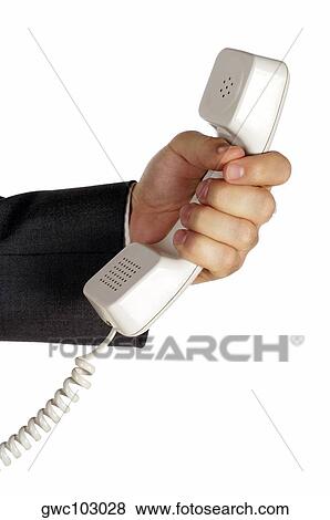 Close-up of a businessman holding a telephone receiver View Large Photo Image Stock Photo - Close-up of a businessman holding a telephone receiver. Fotosearch
