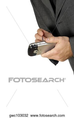 Stock Image - Close-up of a businessman using a personal data assistant. Fotosearch