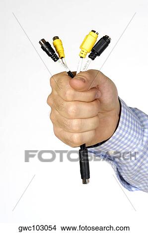 Close-up of a person's hand holding a computer cable View Large Photo Image Picture - Close-up of a person's hand holding a computer cable. Fotosearch