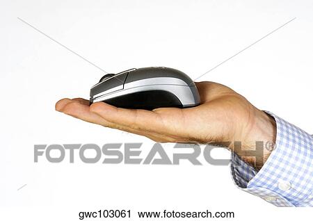 Stock Image - Close-up of a person's hand holding a computer mouse. Fotosearch