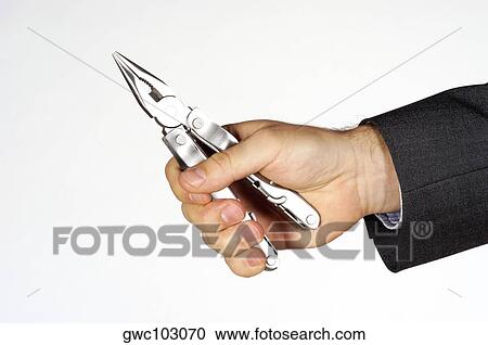 Close-up of a person's hand holding a pair of pliers View Large Photo Image Stock Image - Close-up of a person's hand holding a pair of pliers. Fotosearch