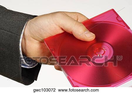 Stock Image - Close-up of a person's hand holding a compact disk. Fotosearch