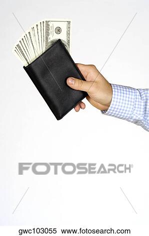 Close-up of a person's hand holding a wallet View Large Photo Image Stock Photography - Close-up of a person's hand holding a wallet. Fotosearch