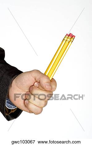 Close-up of a person's hand holding three pencils View Large Photo Image Stock Photo - Close-up of a person's hand holding three pencils. Fotosearch
