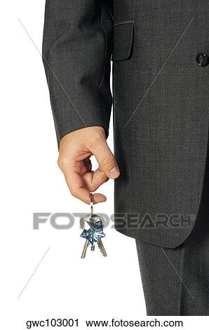 Mid section view of a businessman holding keys View Large Photo Image Stock Image - Mid section view of a businessman holding keys. Fotosearch