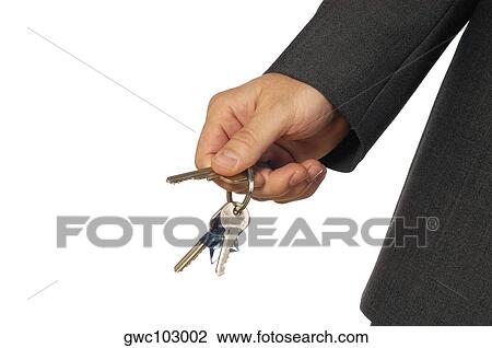 Stock Image - Mid section view of a businessman holding keys. Fotosearch