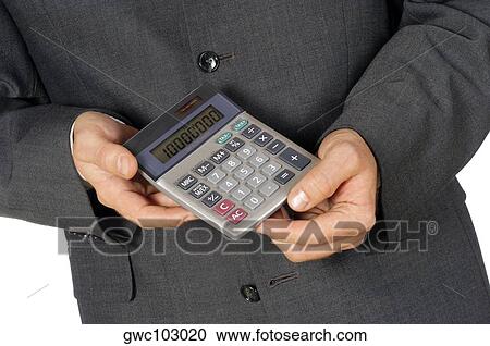 Mid section view of a businessman holding a calculator View Large Photo Image Stock Image - Mid section view of a businessman holding a calculator. Fotosearch