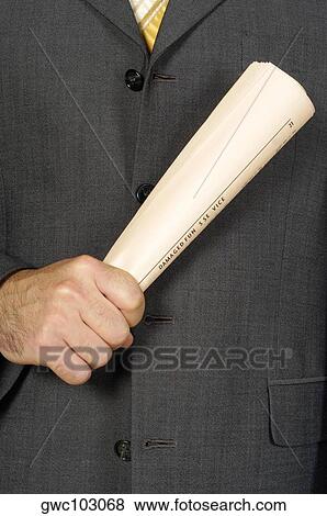 Mid section view of a businessman holding a newspaper View Large Photo Image Stock Photo - Mid section view of a businessman holding a newspaper. Fotosearch